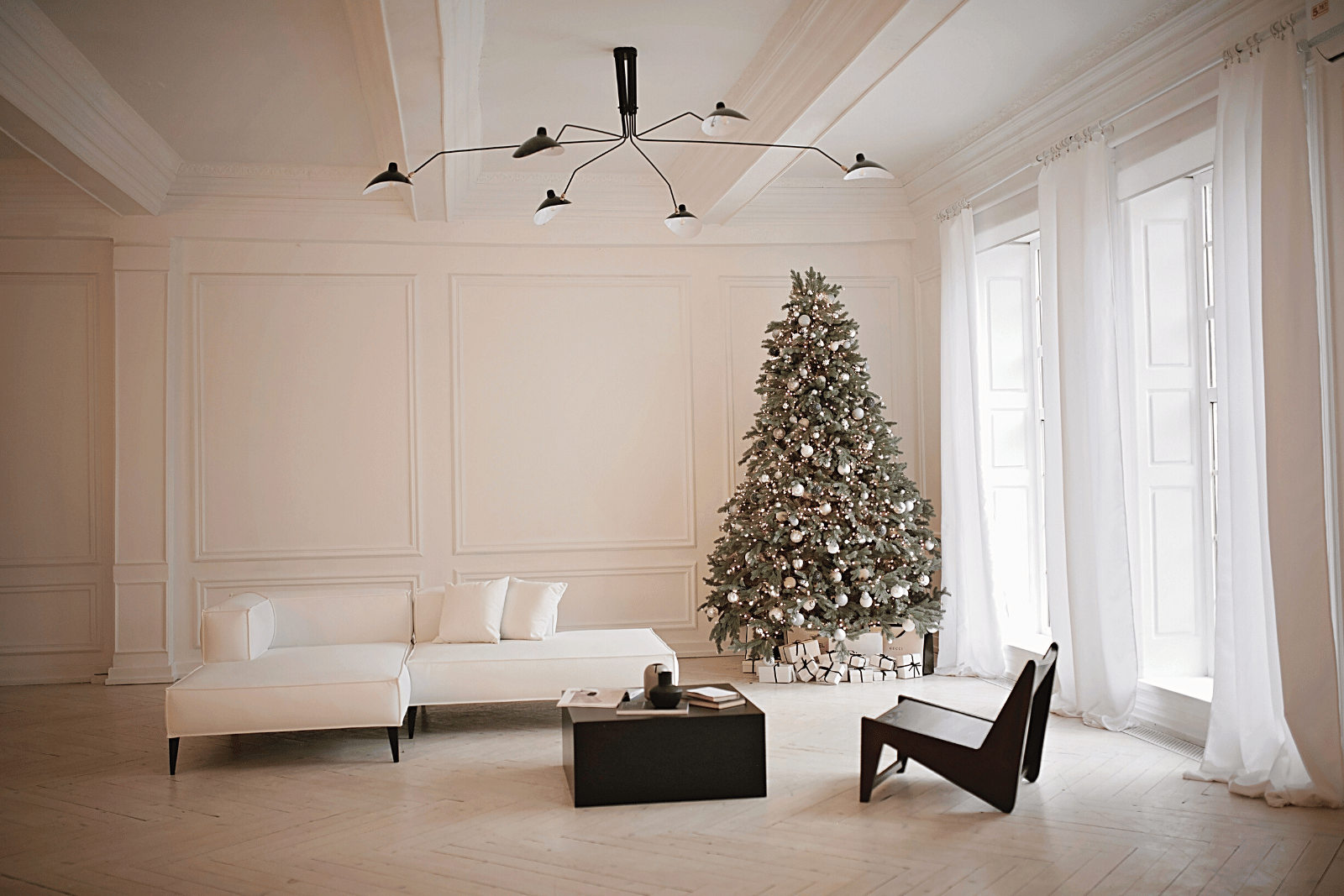 Image featuring a cozy minimalist living room adorned with a festive Christmas tree and a comfortable couch, creating a warm holiday ambiance