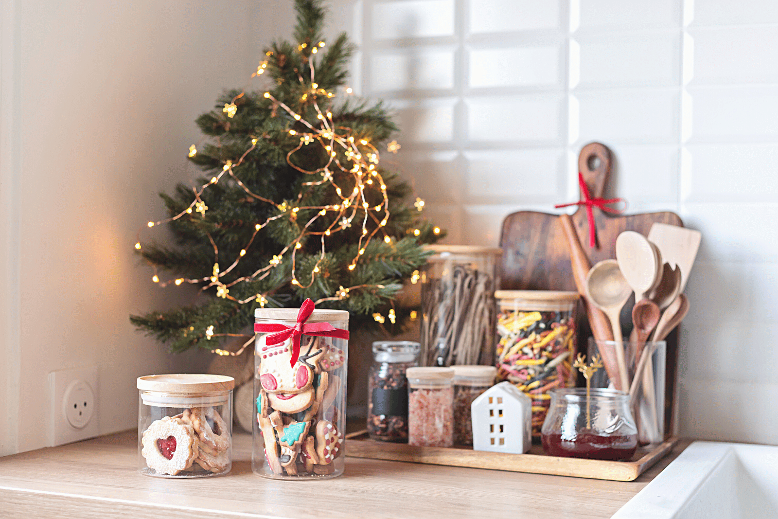 Image featuring a festive organized kitchen counter adorned with a Christmas tree, cookies, and other holiday decor