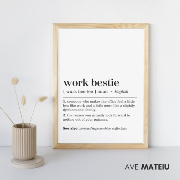 Image featuring the wooden canva frame with the text: Work Bestie Definition Printable Minimalist Wall Art + the definition of the noun word 'work bestie': [ wurk bes-tee ] noun 1. someone who makes the office feel a little less like work and a little more like a slightly dysfunctional family. 2. the reason you actually look forward to getting out of your pajamas. See also: personal hype machine, coffee fairy