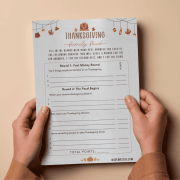 Thanksgiving Family Feud Printed Printed Thanksgiving Family Feud game sheet on cozy autumn table — easy printable Thanksgiving party game for families.