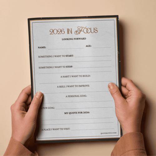 Two hands hold a 2026 goal-setting sheet on beige background. The sheet includes fields for name, age, goals, and a personal quote, set in an elegant design.